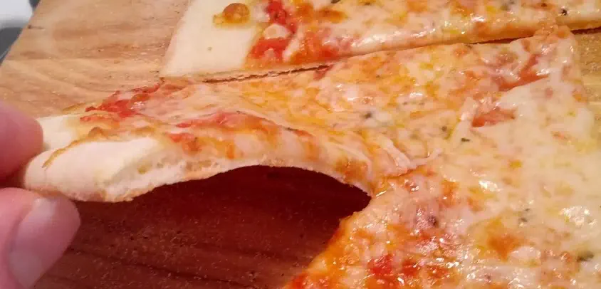 A flat, dense pizza crust