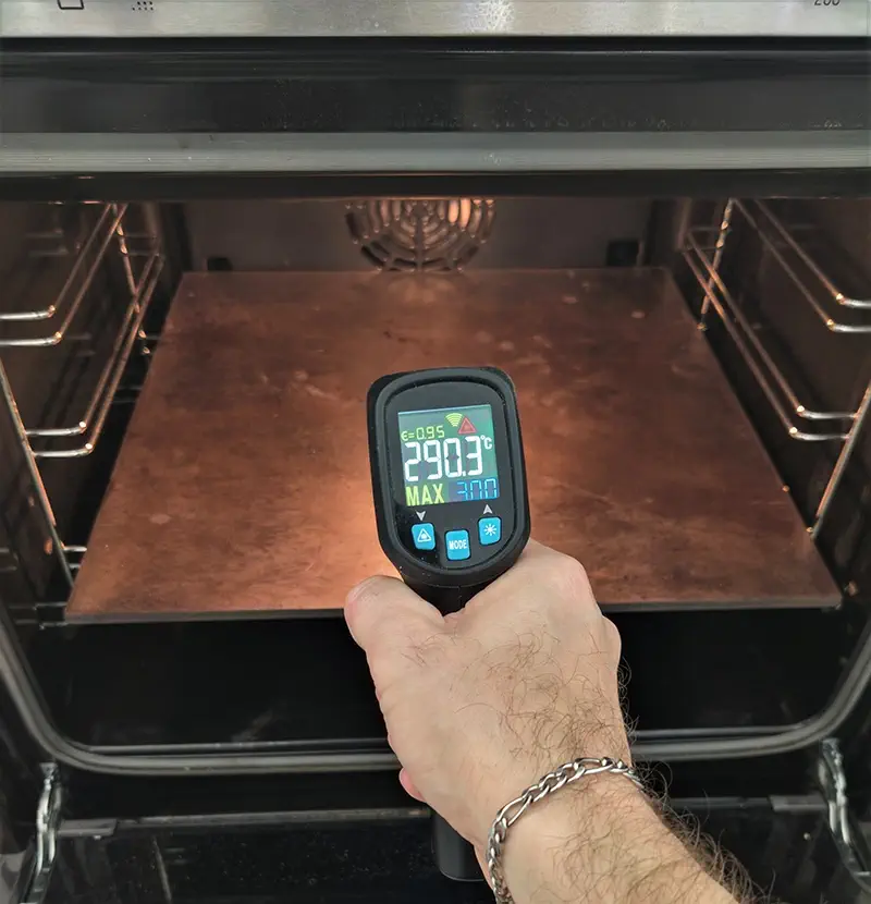 Checking the temperature of a baking surface using an infrared thermometer
