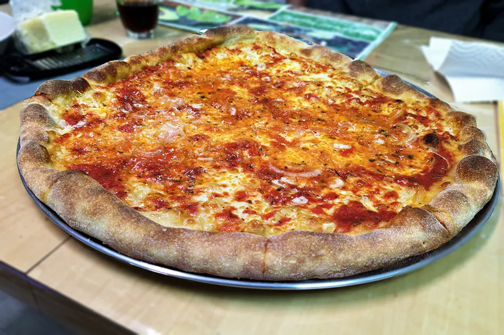 An uncut New York style pizza