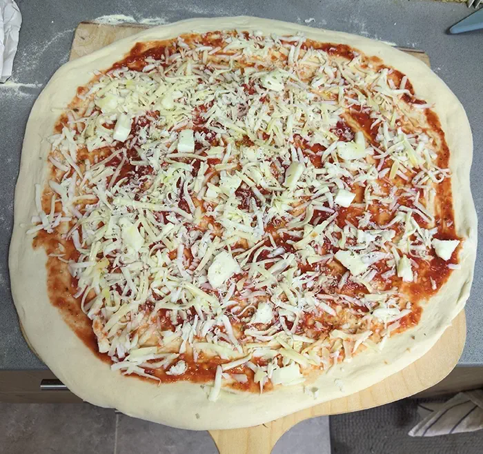 A 16-inch pizza, fully dressed and ready to be transferred to the oven