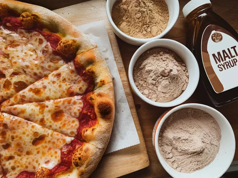 Bowls of malt powder next to a baked pizza