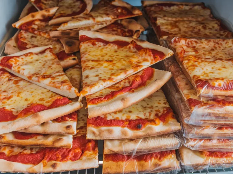 Slices of pizza stacked and stored in the freezer