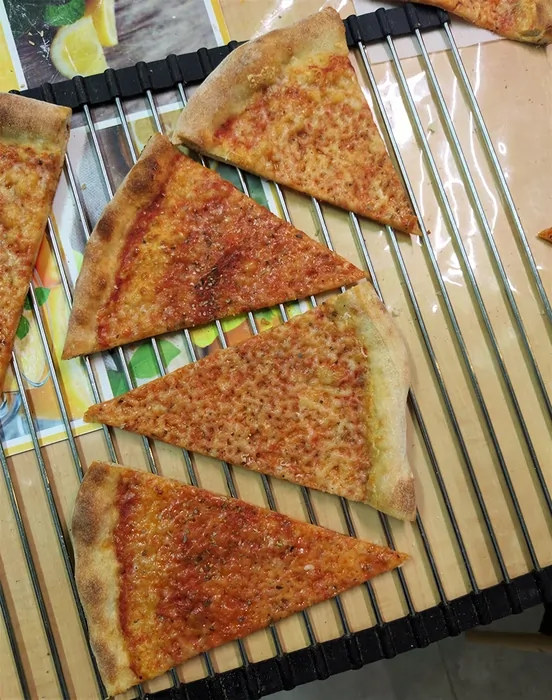 Pizza slices with different types of cheese applied to them