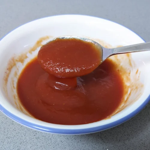 A bowl with pizza tomato sauce