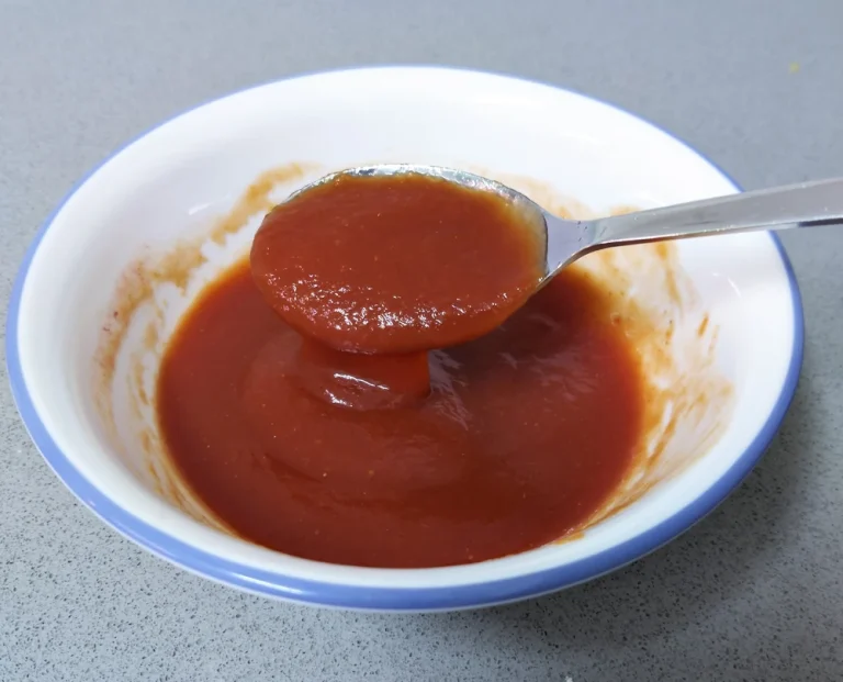A bowl with pizza tomato sauce